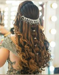 Hairstylist creating an intricate updo with decorative pins and flowers, in a bright and welcoming salon environment